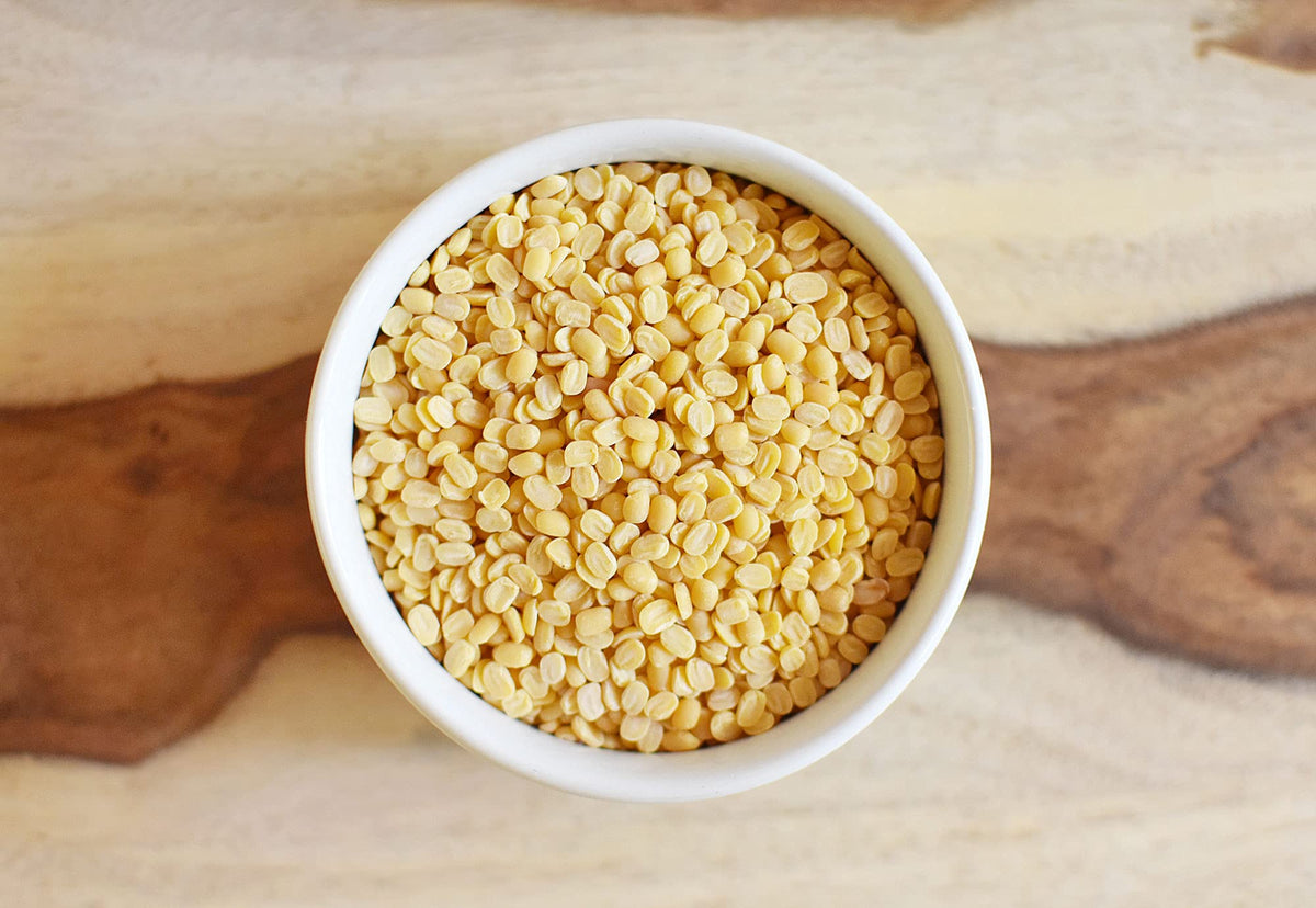 Anthony's Organic Split Yellow Mung Beans raw lentils on counter, ideal for versatile curries or soups.