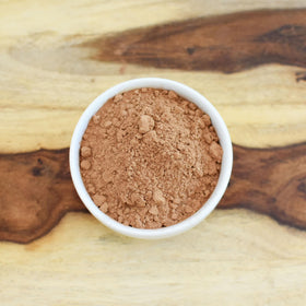 Anthony's Cocoa Powder in a baking setup, versatile for vegan recipes.