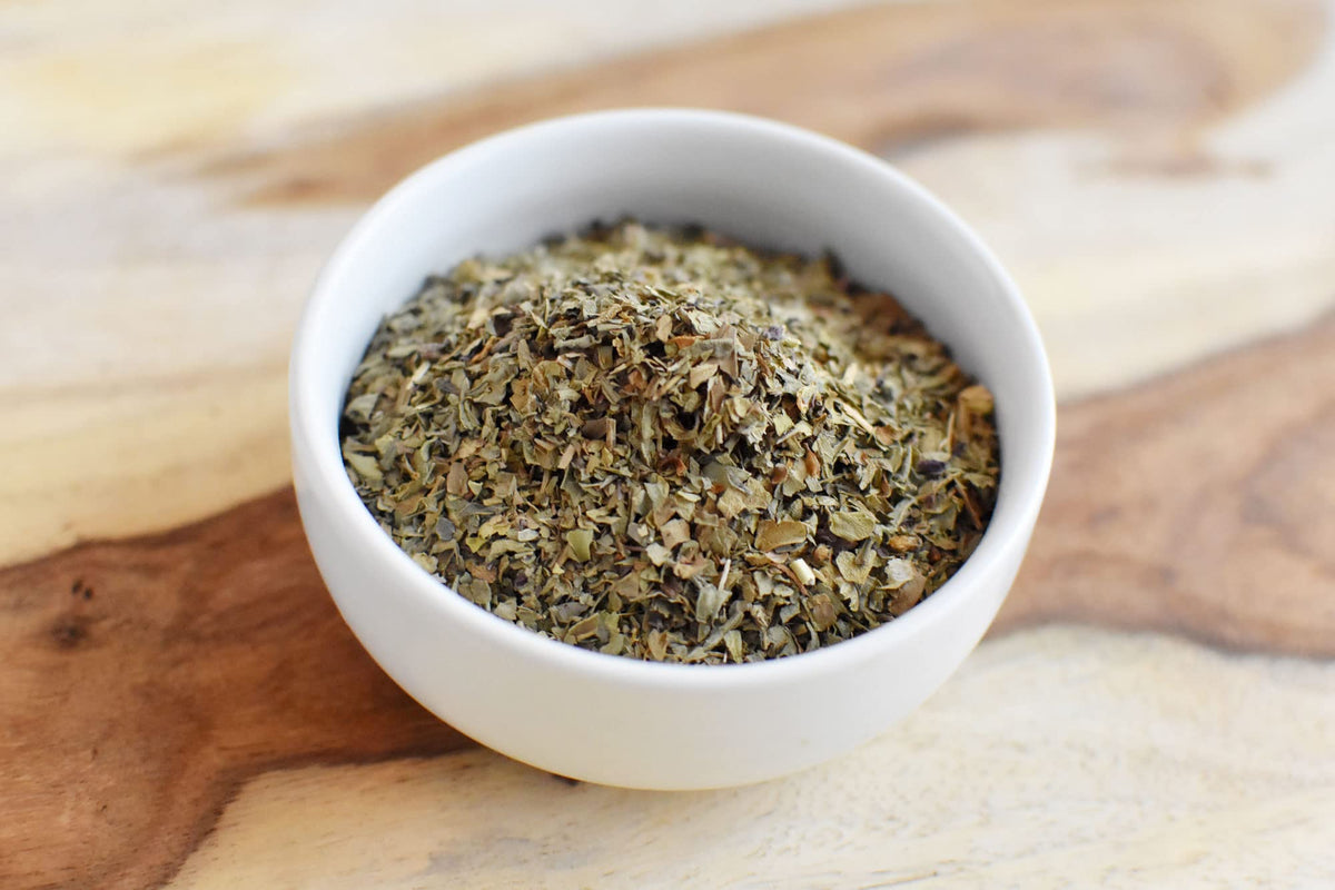 Anthony's Organic Dried Basil Leaves on pasta dish highlighting bright aroma.