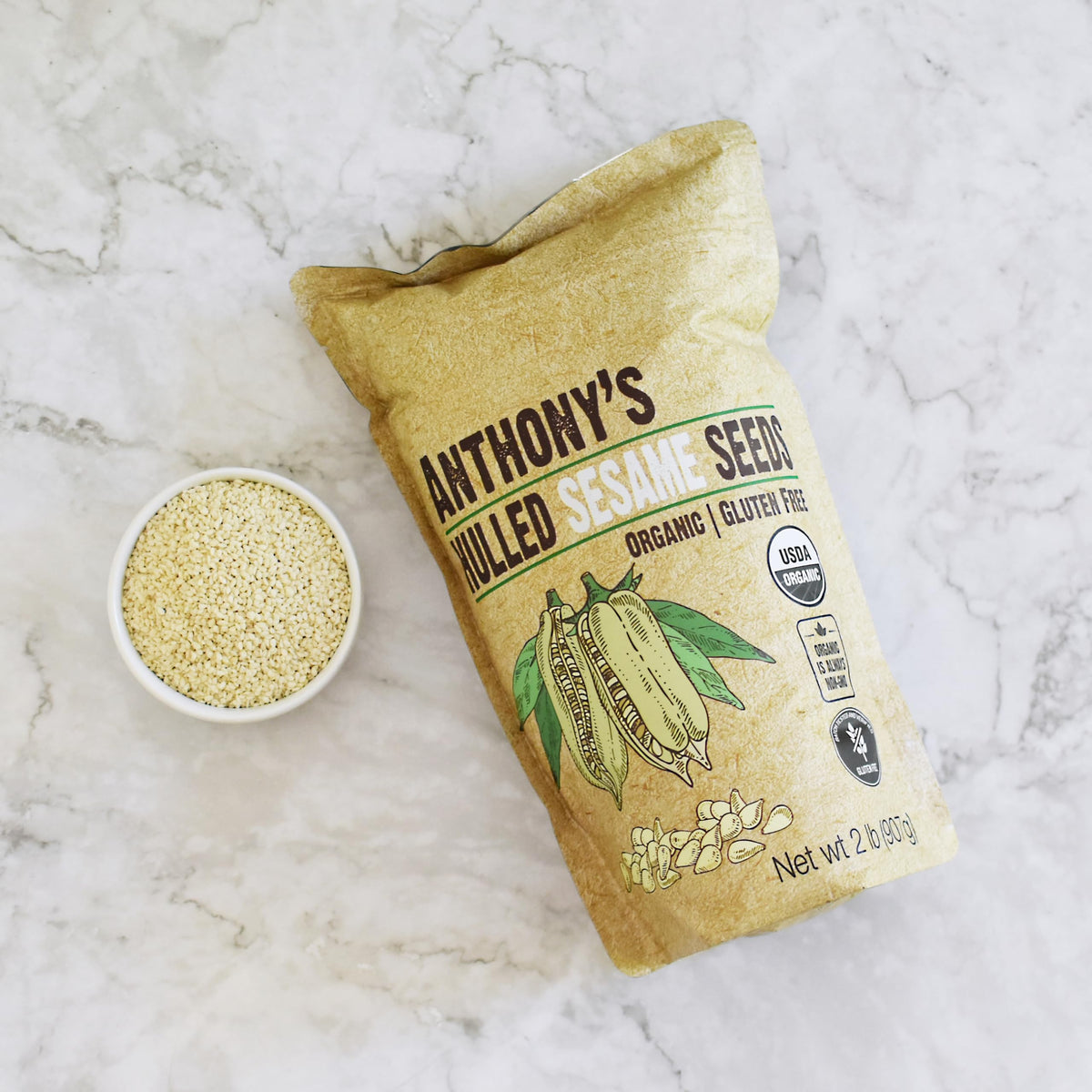 Anthony's Organic Hulled Sesame Seeds over granola, showcasing fiber and copper benefits