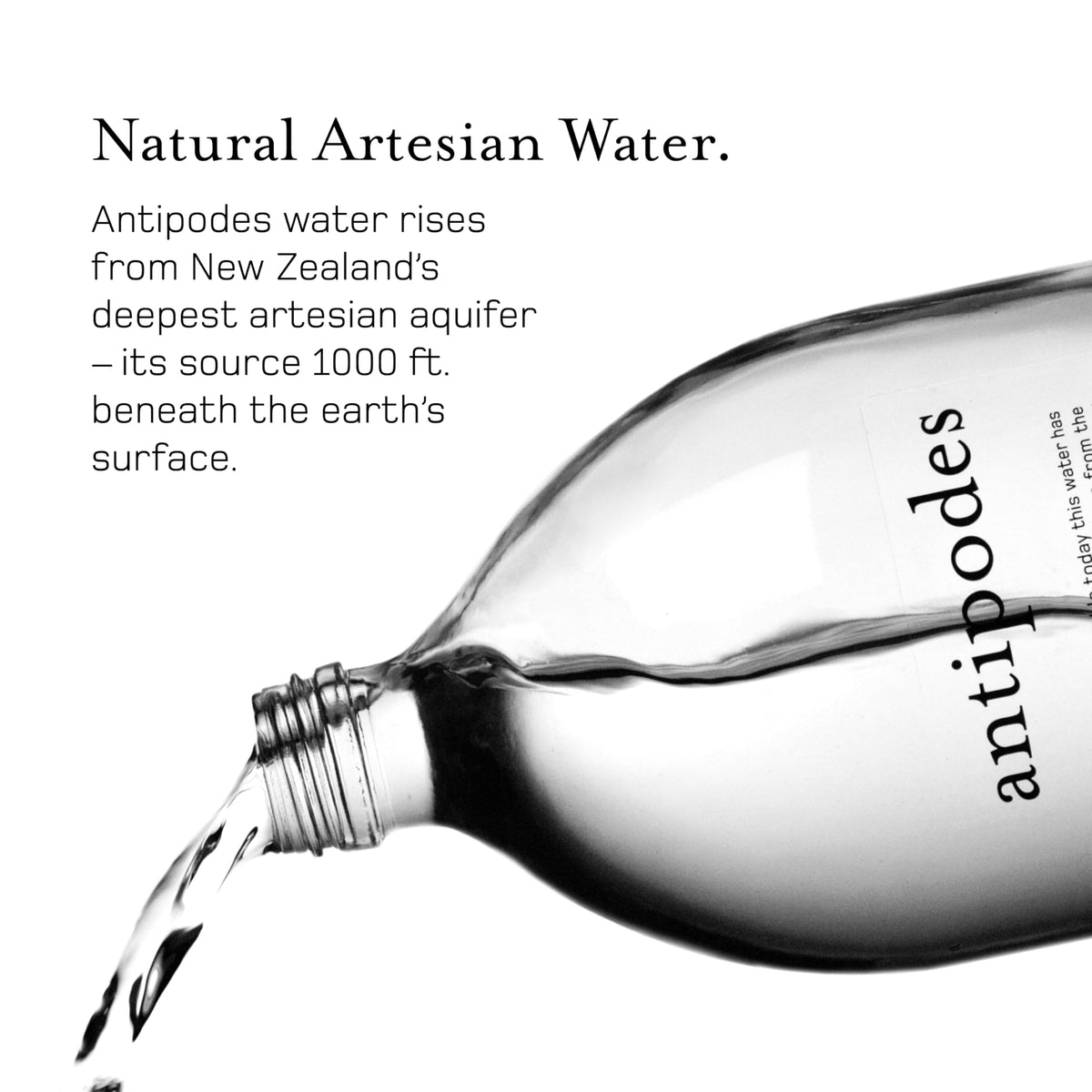 Antipodes natural artesian water glass bottle label close-up, premium branding signals quality.