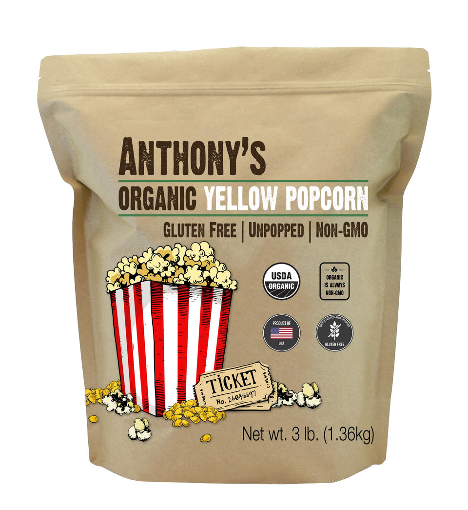 Anthony's Organic Yellow Popcorn Kernels uncooked on a board, ideal for gluten-free snacking.