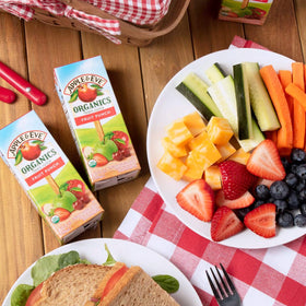 Glass of Apple & Eve Organics juice highlighting 100% fruit goodness.