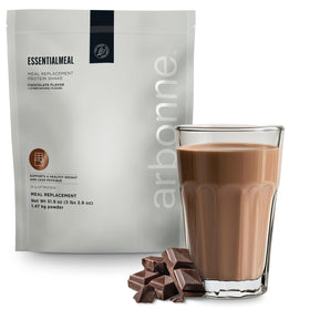 Arbonne EssentialMeal chocolate shake in a glass, a protein-packed meal replacement.