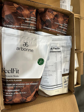 Arbonne EssentialMeal shake with a rich chocolate foam texture in a glass.