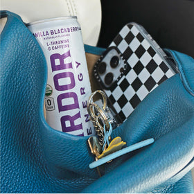 Holding an ARDOR Energy can during study or workout.