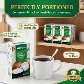 Aroy-D Organic Coconut Milk pour with spoon for creamy desserts and curries.