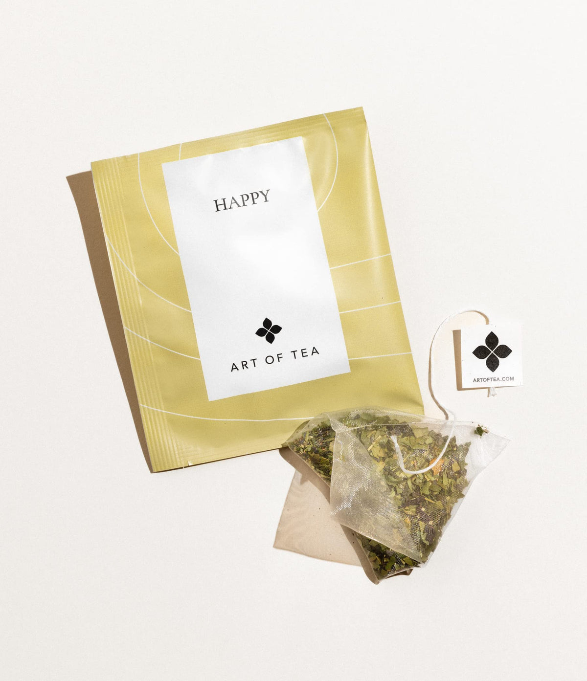 Art of Tea Organic Happy Tea sachet opened to reveal berries and jasmine aroma.