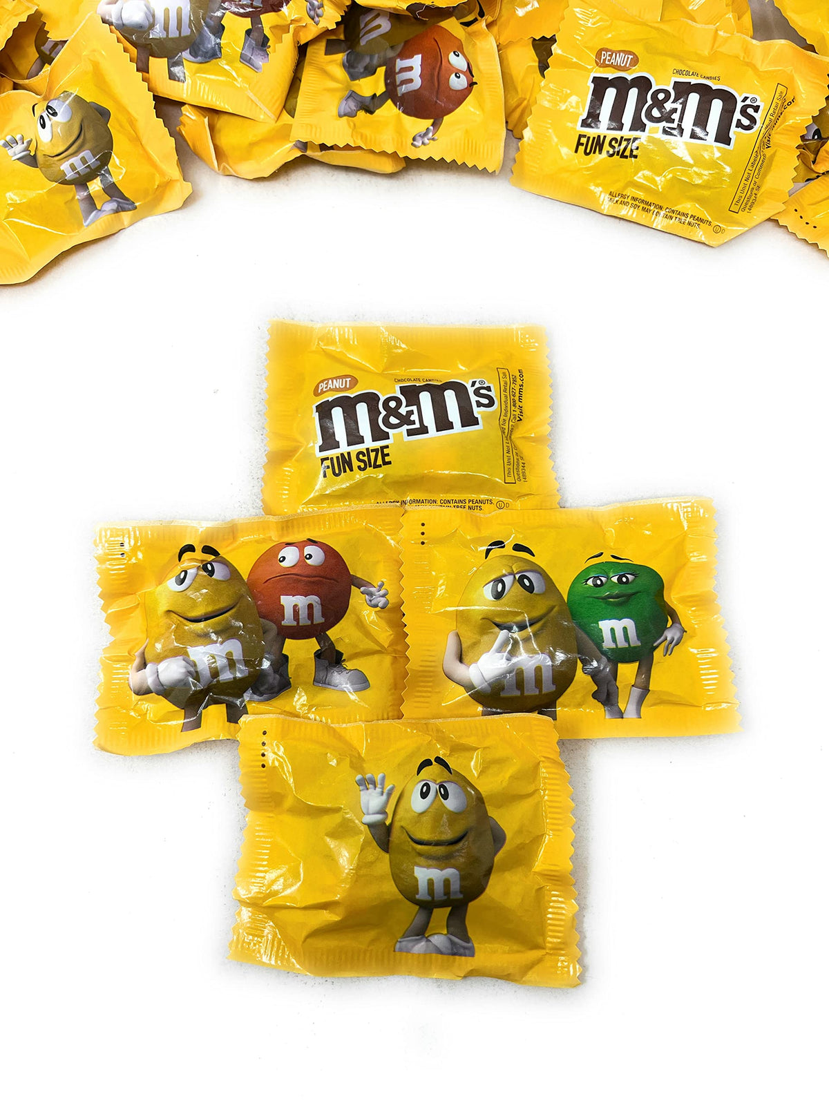 Assortit M&amp;M peanut milk chocolate wrappers shown for fresh, single portions.