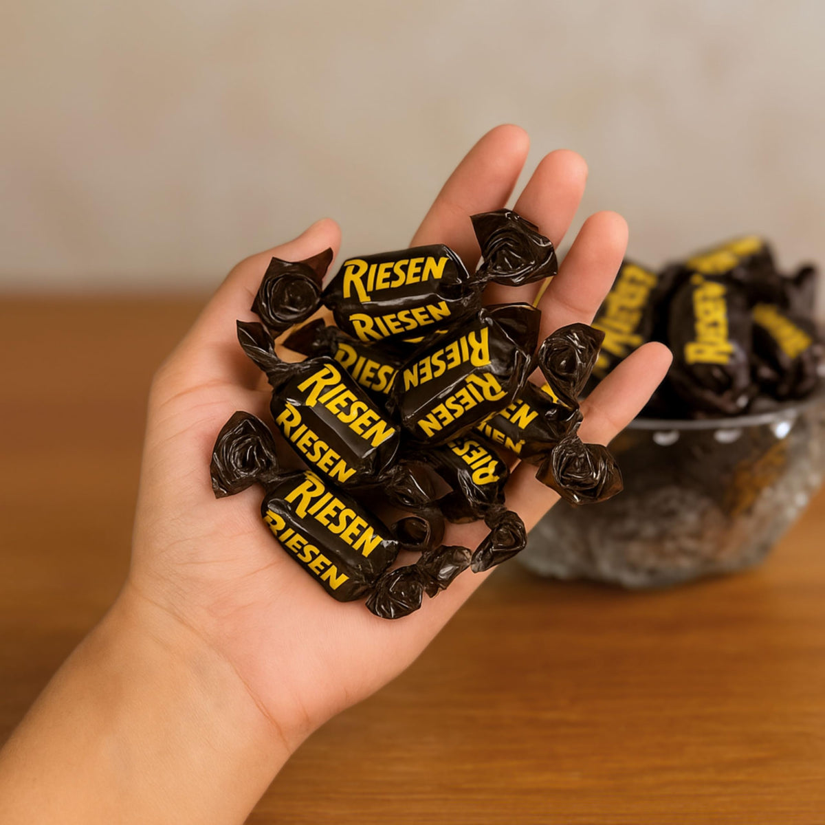 Assortit Riesen caramel shell closeup highlights smooth chocolate shell over chewy caramel.