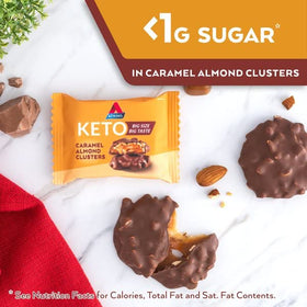 Carton display of Atkins Caramel Almond Clusters for family snacking.