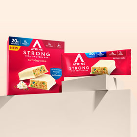 Atkins Strong Birthday Cake bar texture close-up, creamy center and chewy crust.