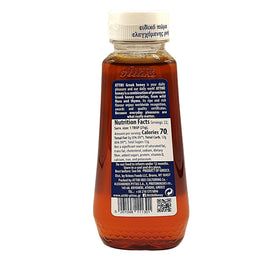Pouring Attiki honey to showcase herbal aroma and smooth flow for recipes.
