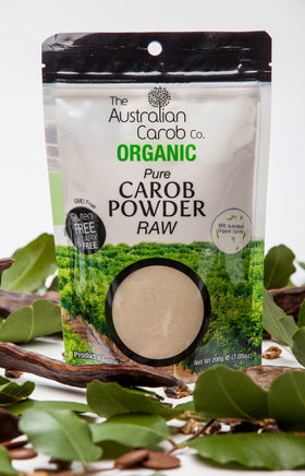 The Australian Carob Co. raw organic carob powder being poured for quick, versatile mix-ins.