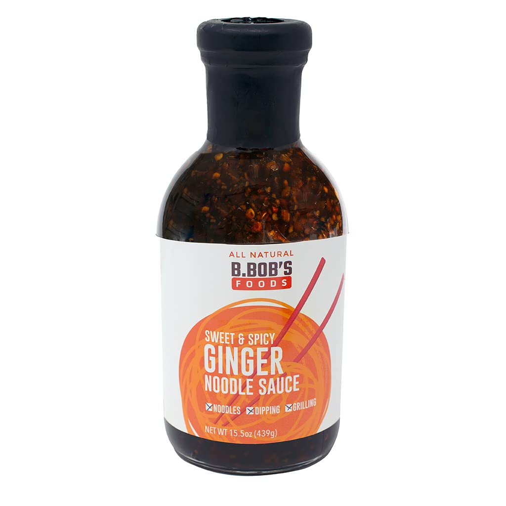 B Bob’s Sweet and Spicy Ginger Noodle Sauce bottle pouring over dumplings for dipping