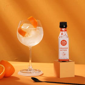 Close-up of Bab Louie & Co. Orange Bitters adding depth to cocktails.