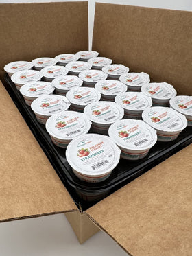 Backpack Yogurt Strawberry 4 oz cup shown in a lunchbox for on-the-go real fruit snack.