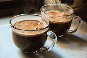 Bare Life Coconut Hot Cocoa being poured into hot water for a quick cup
