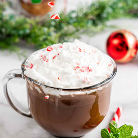 Bare Life hot cocoa mug steaming with peppermint aroma for a cozy treat.