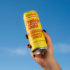 Barebells Protein Soda Pineapple Sunrise label highlights caffeinated refreshment for daily energy.