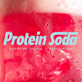 Barebells protein soda sweet cherry pour capturing a bubbly splash ready to sip.