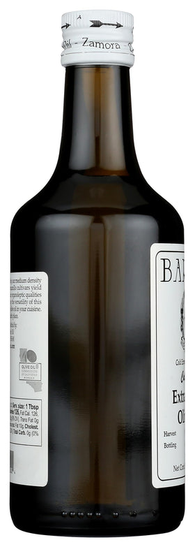 Bariani olive oil being poured over salad for brightness
