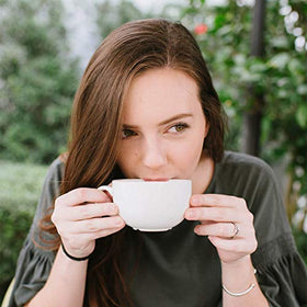 Barnie's Coffee caramel ground coffee being poured into a mug for a comforting brew