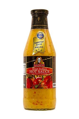 Baron West Indian Hot Sauce being poured over grilled foods.