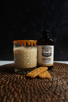 Barrel Roll Demerara syrup hand bottling signifies small-batch quality and craft.