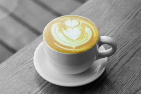 Golden Chai poured into a glass with creamy foam.