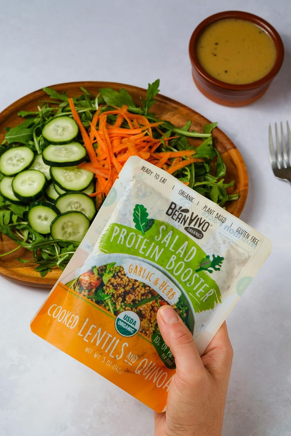 BeanVIVO serving spoon in salad featuring vibrant ingredients.