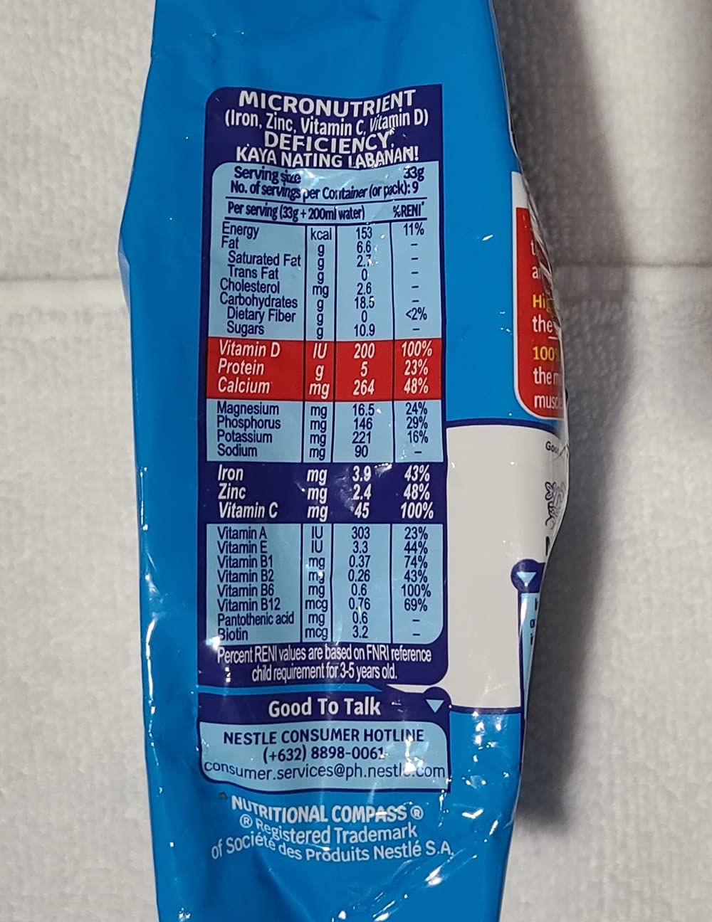 Bear Brand fortified powdered milk 2-pack pouring into glass, versatile for drinks and recipes.