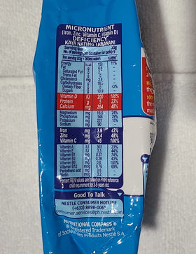 Bear Brand fortified powdered milk 2-pack pouring into glass, versatile for drinks and recipes.