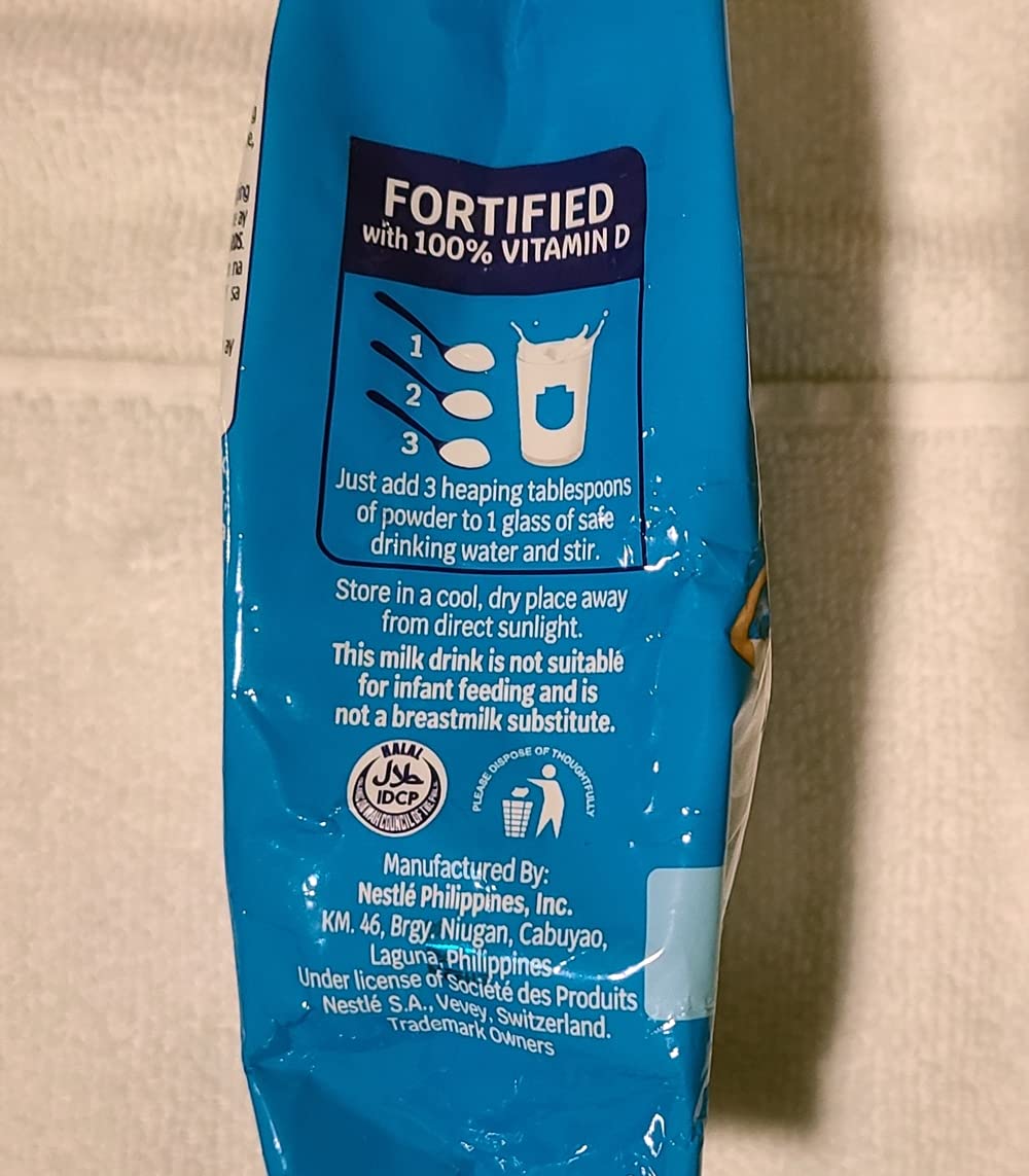Bear Brand fortified powdered milk 2-pack scoop presentation, easy mixing for beverages.