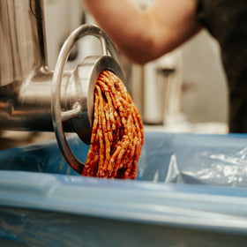 Bearded Butchers Classic Bratwurst seasoning being poured during prep
