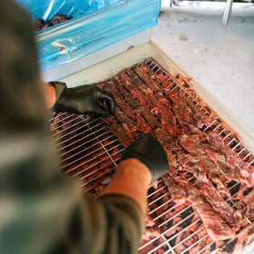 Outdoor prep scene for camping jerky using Bearded Butchers clean-label ingredients.