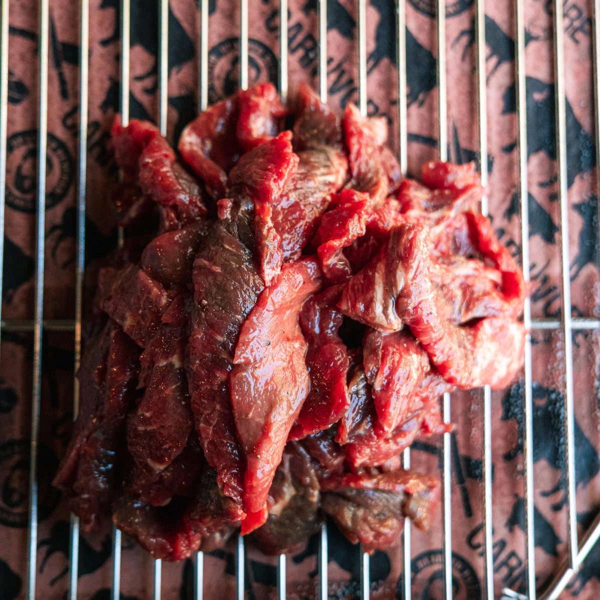 Raw beef with Bearded Butchers seasoning ready to marinate into jerky.