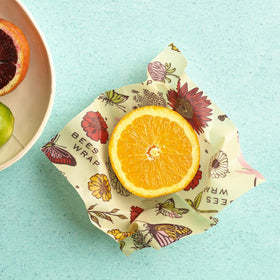 Hands washing Bee's Wrap vegan wrap demonstrating washable and reusable use