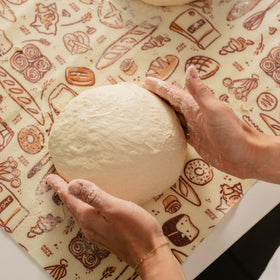 Bread dough resting under Bee's Wrap during proofing