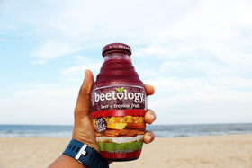 Beetology juice in a glass with fruit, highlighting color and versatility