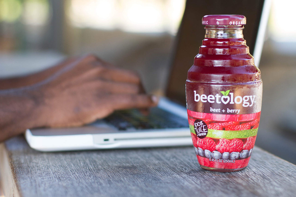 Beetology pouring juice into glass reveals a vivid color and fresh taste.