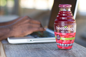 Beetology pouring juice into glass reveals a vivid color and fresh taste.