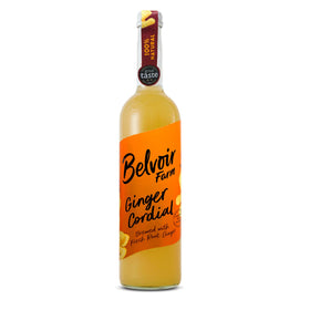 Belvoir Ginger Cordial bottle being poured, a vibrant mixer for cocktails and mocktails.