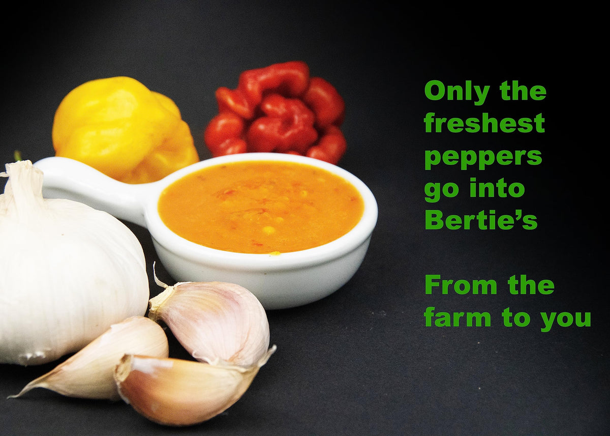 Pouring Bertie's sauce to show its smooth, thick texture and fruity heat.