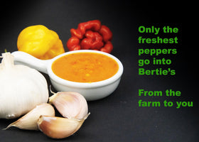 Pouring Bertie's sauce to show its smooth, thick texture and fruity heat.