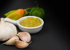 Bertie's Slight Pepper Sauce being poured to flavor meals.