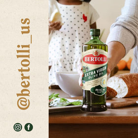 Bertolli Rich Taste bottle beside herbs for a Mediterranean meal.