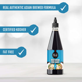 Pouring Best of Thailand vegan fish sauce into a pan.