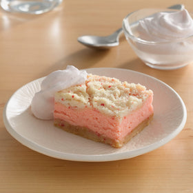 Betty Crocker Cherry Frosting spoon-dipping demonstrates easy spread for cupcakes.