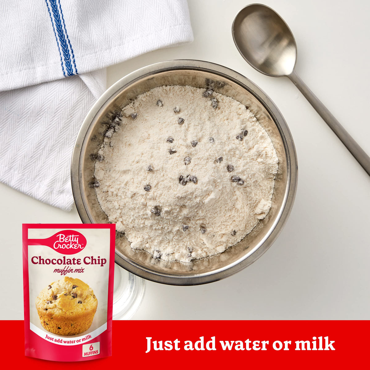 Betty Crocker muffin mix on a baking sheet with golden, fluffy muffins.